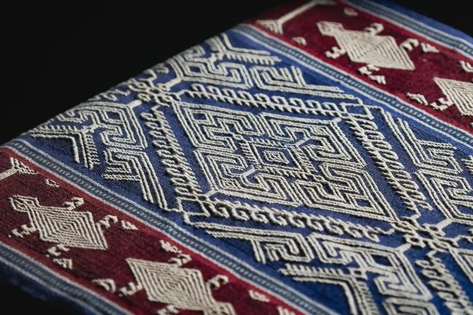 Close detail of a pahikung band in blue, red and white